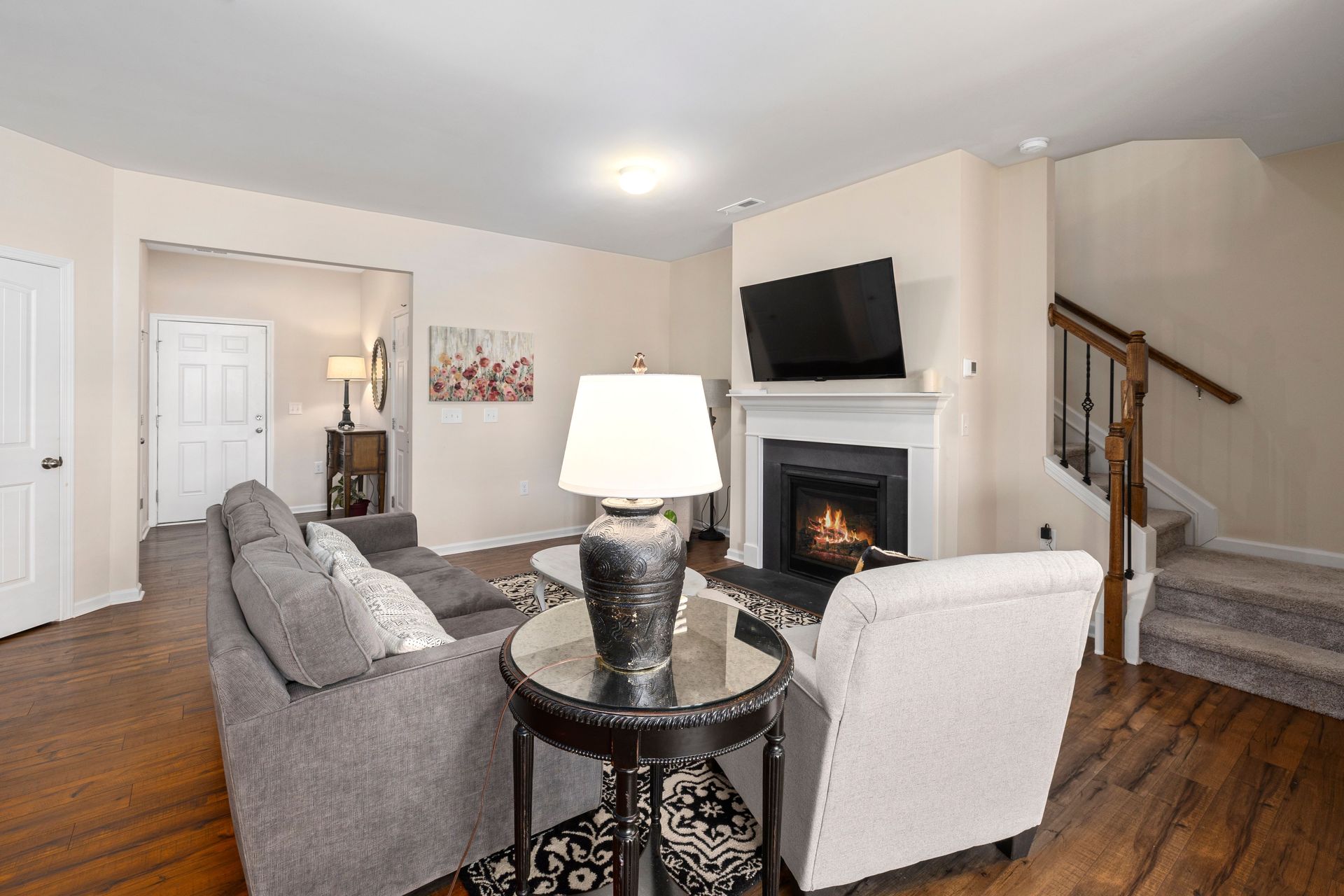 Elegant and cozy living room featuring a fireplace and modern decor, perfect for relaxation.
