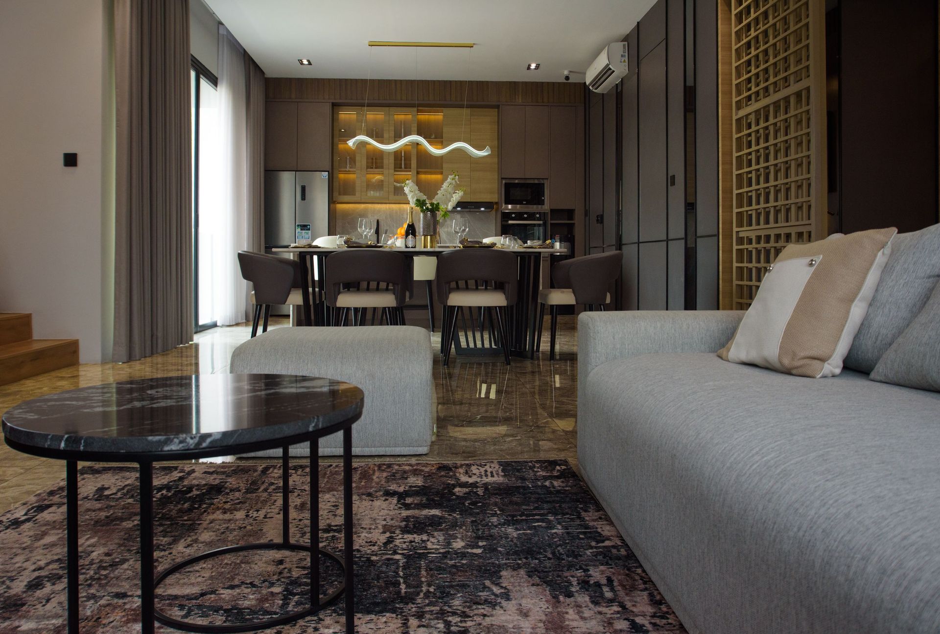 Spacious modern dining and living area with stylish furniture and elegant decor.